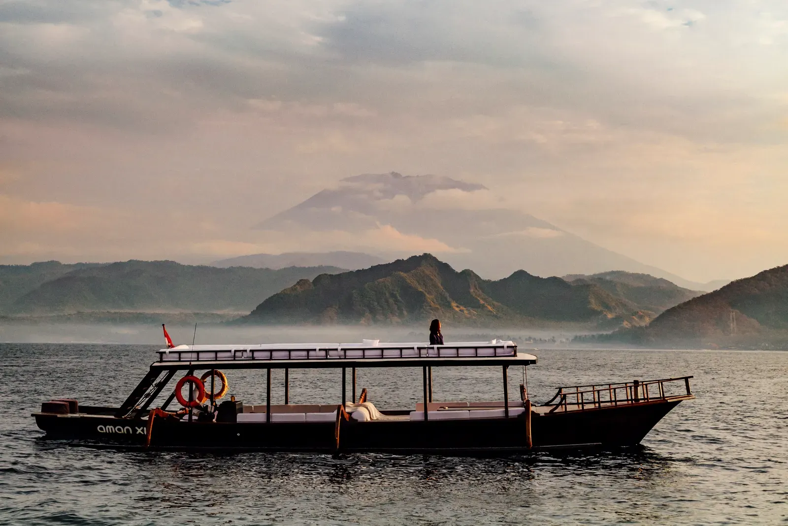 Amankila's signature outrigger sunrise breakfast cruise off the Bali coast