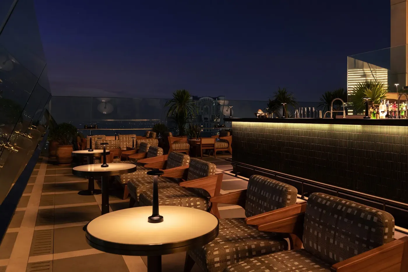 Window seating at Spire Rooftop Bar, Dusit Thani Bangkok, overlooking the Bangkok skyline