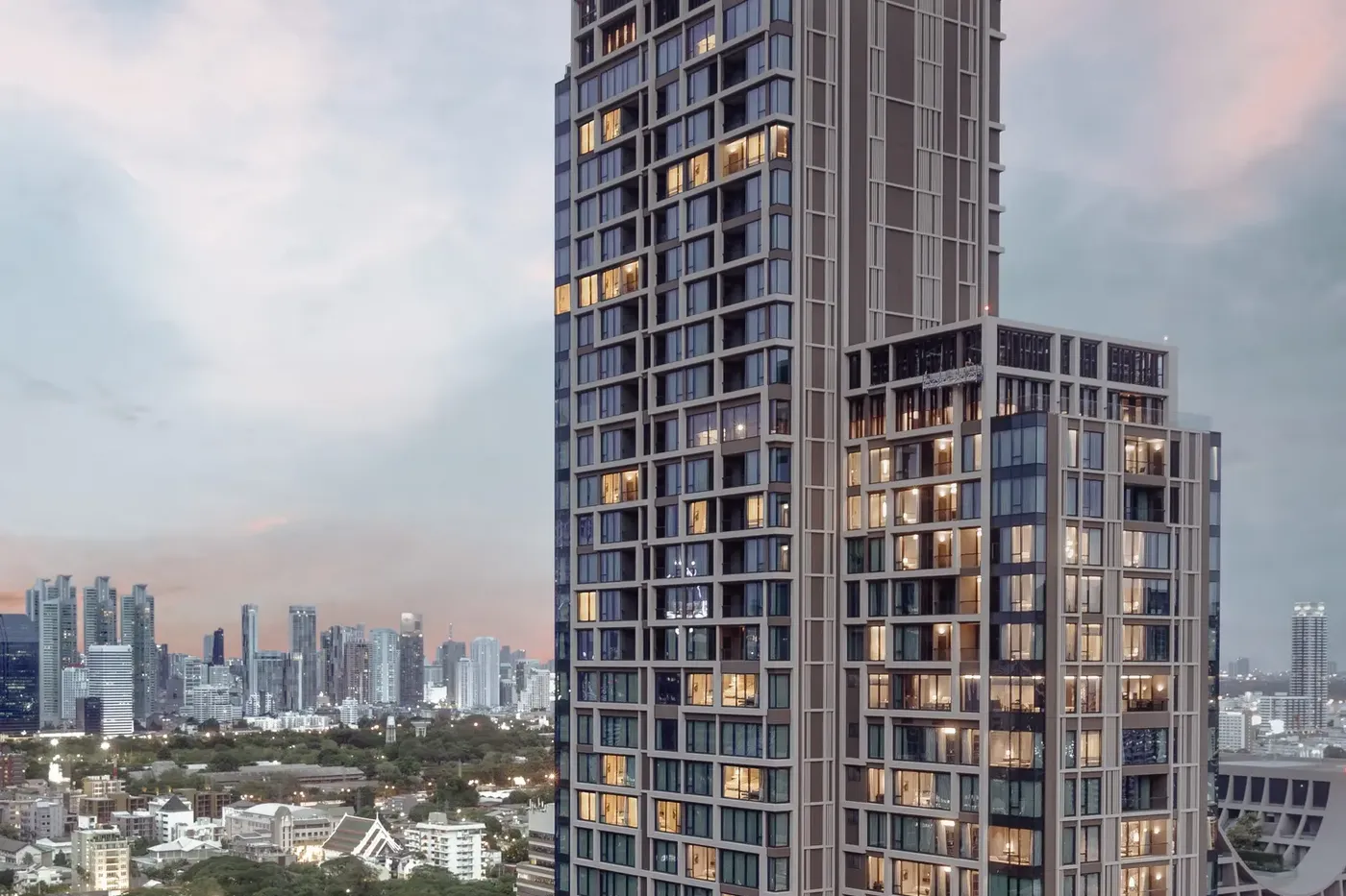 Exterior view of Kimpton Maa-Lai Bangkok's tower against the Bangkok skyline