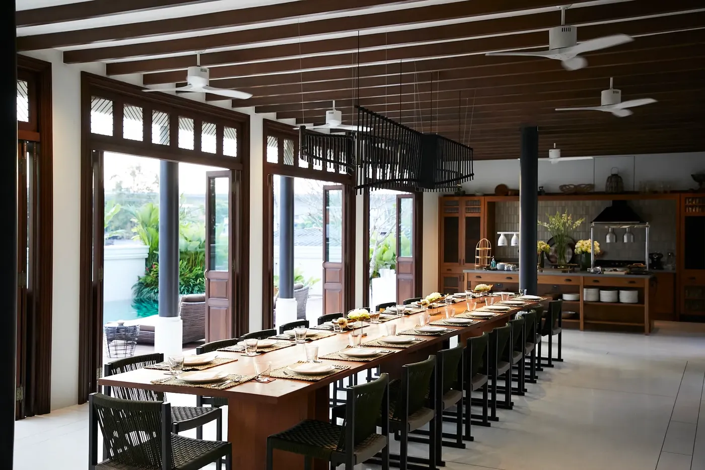 Heritage teak dining table on the villa's old floorboards at Siri Sala Private Thai Villa