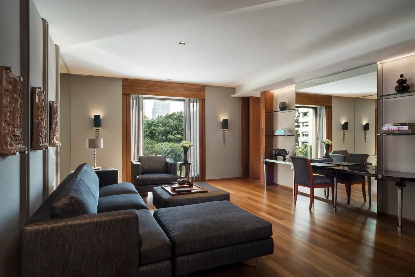The living room of a Club Premier Suite at The Sukhothai Bangkok, overlooking the pool and gardens.