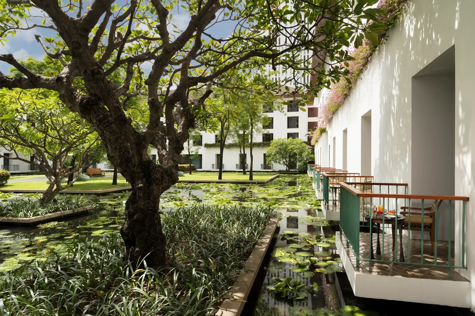 Reflecting lily ponds and the colonnaded courtyard terrace at The Sukhothai Bangkok on South Sathorn Road.
