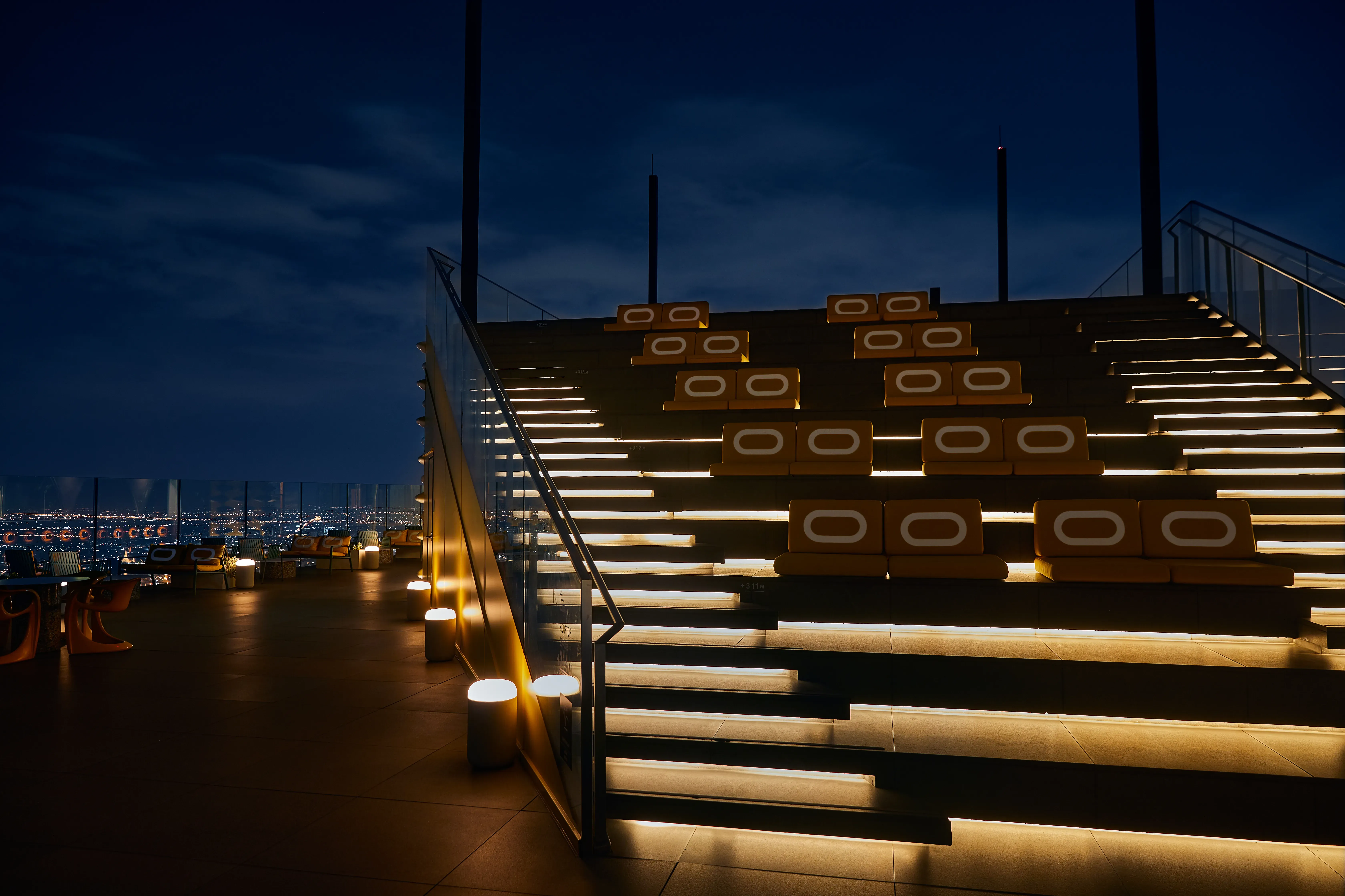 Illuminated rooftop stairs and seating at Sky Beach, The Standard Bangkok Mahanakhon